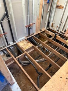 Water piping beneath an opened floor