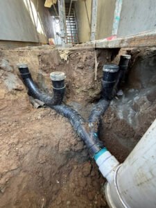 Exposed sewer piping in an excavated trench